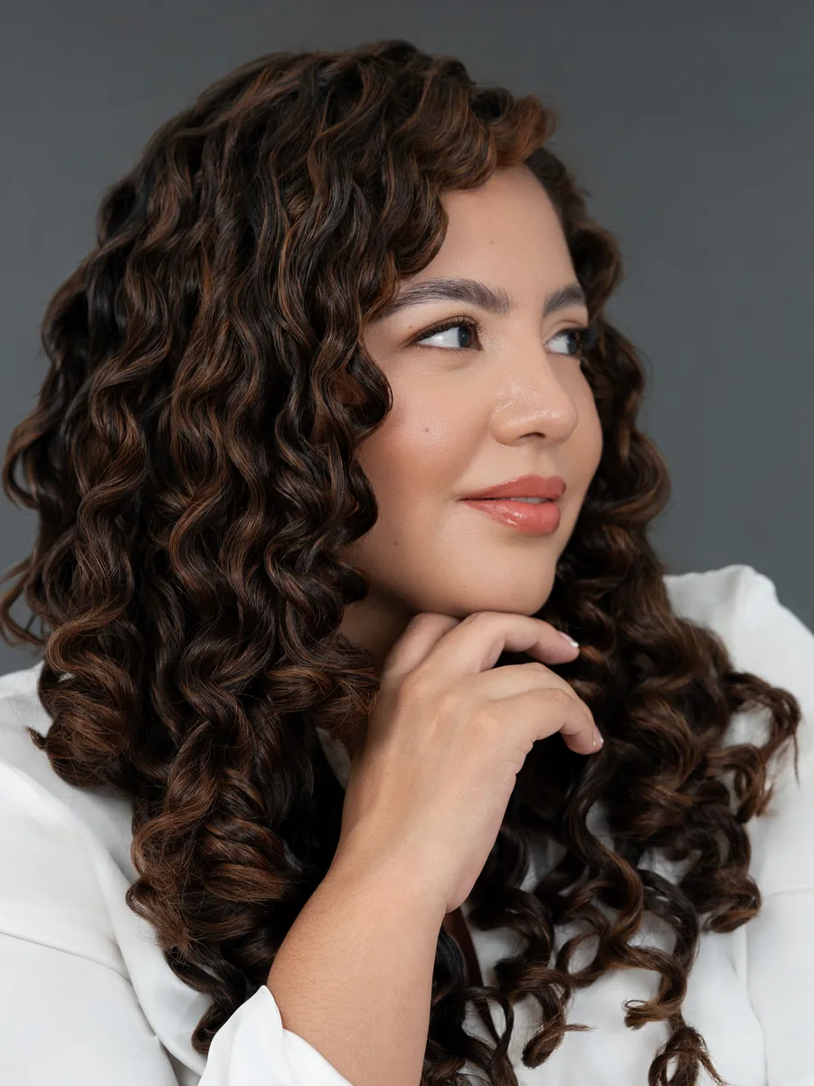Dra. María Fernanda Olarte, médica en Villavicencio, con blusa blanca y la mano en el mentón